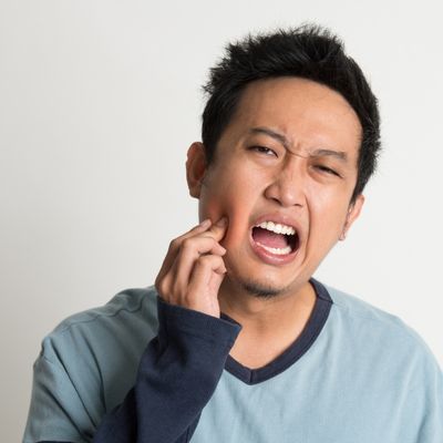 Man with wisdom tooth pain portraying a dental emergency